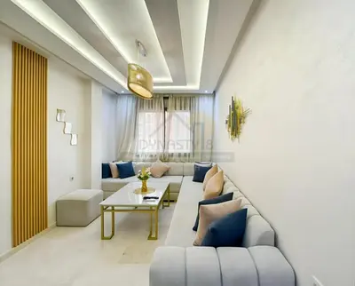 a living room with a couch and a table at Appartement de charme au cœur de la ville rouge in Marrakech