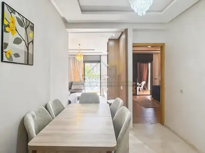 a dining room with a wooden table and chairs at Séjour chic au cœur de Marrakech in Marrakech