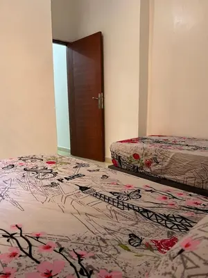 a bedroom with two beds and a door with a flower pattern at Modern Apartment & 8 min from Marrakech Airport in Marrakech