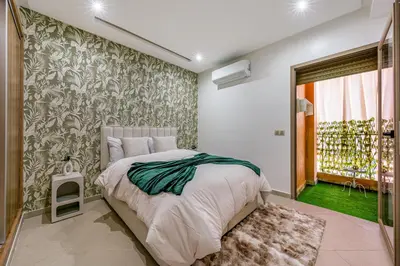 a bedroom with a bed and a wall mural at Studio élégant et paisible au cœur de Marrakech in Marrakech