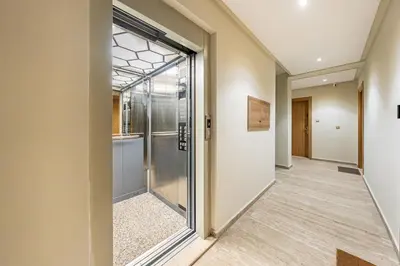 a corridor with a glass door in a building at Studio élégant et paisible au cœur de Marrakech in Marrakech