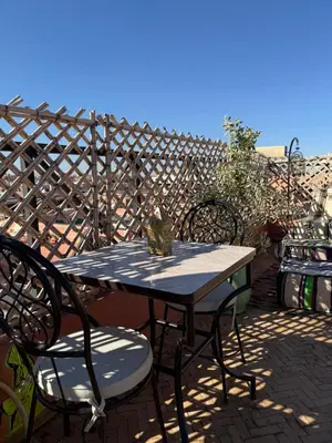 a table and chairs sitting on a patio at Riad R Art in Marrakech