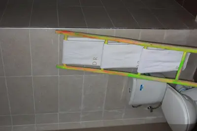 a shelf with three rolls of toilet paper in a bathroom at Riad R Art in Marrakech