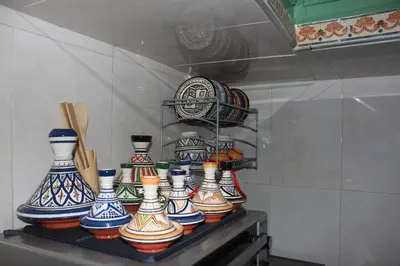 a group of colorful vases sitting on a shelf at Riad R Art in Marrakech