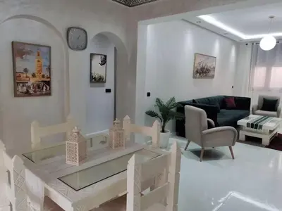 a living room with a table and a couch at HU Aappartement in Marrakech