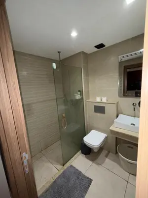 a bathroom with a shower and a toilet and a sink at Luxury 2-room apartment - Pool view in Marrakech