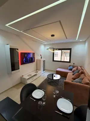 a living room with a table and a couch at Luxury 2-room apartment - Pool view in Marrakech