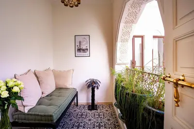 a living room with a couch and a window at Riad Anaqa in Marrakech