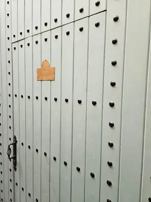 a metal door with a sign on it at Douiria des Loulous in Marrakech