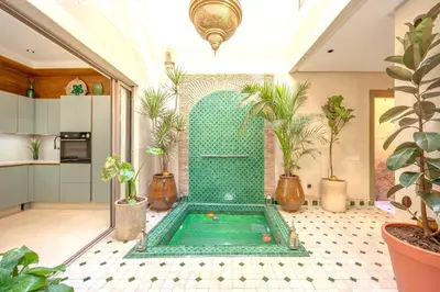 a pool in the middle of a room with plants at Riad Garden View in Marrakech