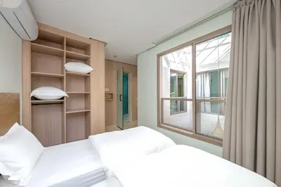 two beds in a room with a window at Riad Garden View in Marrakech
