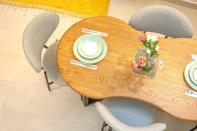 a wooden table with plates and flowers on it at Riad Garden View in Marrakech