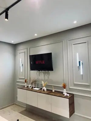 a living room with a television on a wall at Chic apartment in a secure residence in Marrakech