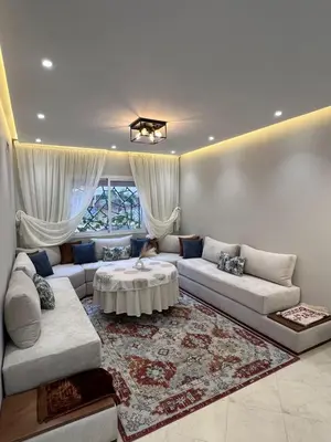 a living room with a couch and a table at Chic apartment in a secure residence in Marrakech
