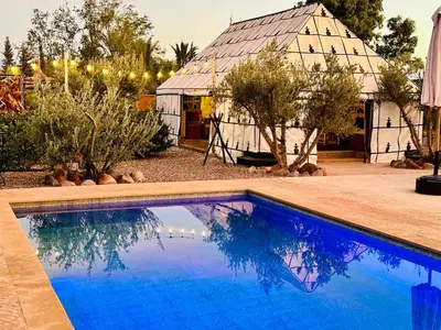a swimming pool in front of a house at Villa Romana in Marrakech