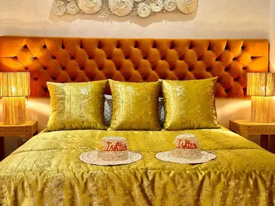 a bedroom with a bed with two hats on it at Villa Romana in Marrakech