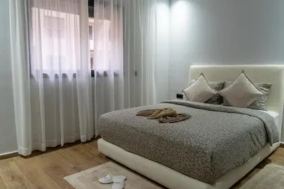 a bedroom with a bed with a towel on it at luxury white & beige Apartment in Marrakech