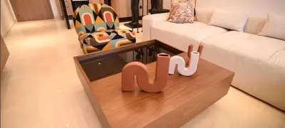 a living room with a couch and a sign that saysku at Luxury Apartment in Marrakech