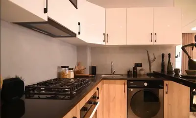 a kitchen with white cabinets and a stove top oven at Luxury Apartment in Marrakech