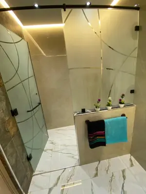 a bathroom with a shower and a blue towel at Appartement neuf et équipé, proche de commodités in Marrakech