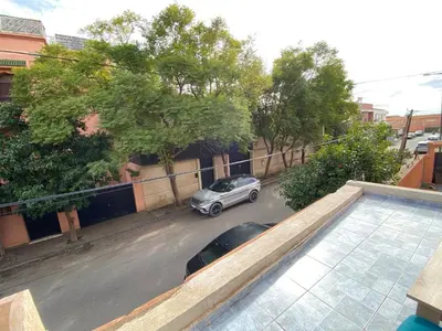 a car parked in a parking lot on a street at Appartement neuf et équipé, proche de commodités in Marrakech