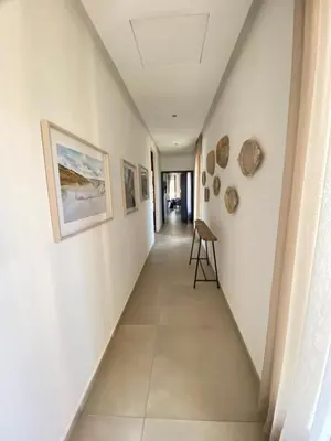 a hallway in a house with white walls at Villa Ines Piscine chauffée & Jacuzzi & Hammam in Marrakech