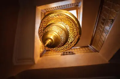 a gold door knob hanging from a wall at Riad 16 Dar and Pool in Marrakech