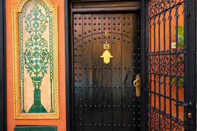 a door to a house with a sign on it at Riad 16 Dar and Pool in Marrakech