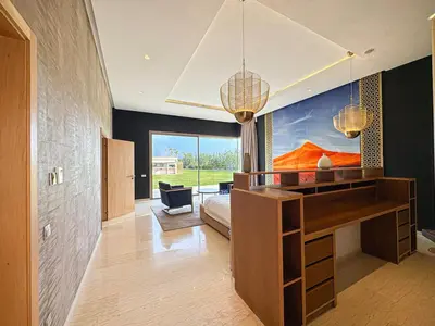 a bedroom with a desk and a bed in a room at Private Mountain View Oasis in Bou Azza