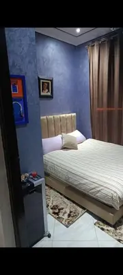 a bedroom with a bed in a room with blue walls at Afaq1,saada in Marrakech