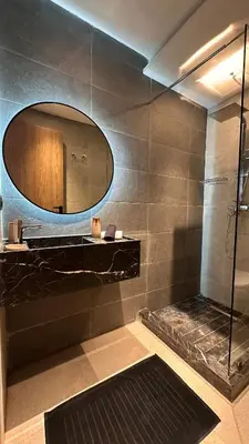 a bathroom with a mirror and a shower at Marrakesh Heated Pool Sport and Jacuzzi in Marrakech