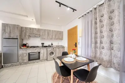a kitchen with a table and chairs in a room at The best JINANE in Marrakech