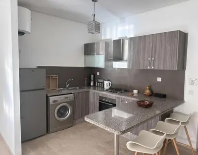 a kitchen with a sink and a washing machine at Studio Premium au Cœur de Guéliz in Marrakech