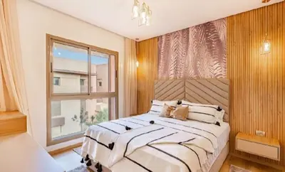 a bedroom with a large bed and a window at Prestigia Golf Resort Luxury in Marrakech