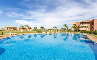 a large blue swimming pool in a resort at Prestigia Golf Resort Luxury in Marrakech