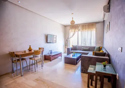 a living room with a couch and a table at Le Chic Urbain Tout à Pied Clim Design Chic in Marrakech