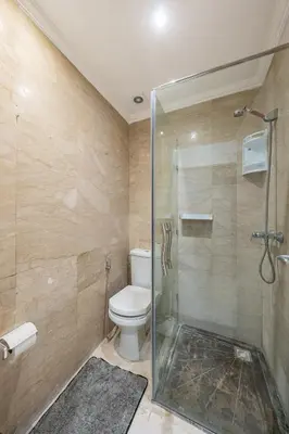 a bathroom with a toilet and a glass shower at Horizon Cozy terrace and serenity in Marrakech