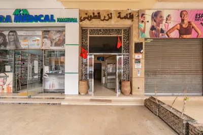 an entrance to a store with glass doors and posters at Horizon Cozy terrace and serenity in Marrakech