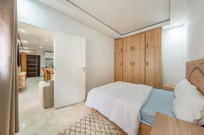a bedroom with a bed and a sliding glass door at Horizon Cozy terrace and serenity in Marrakech