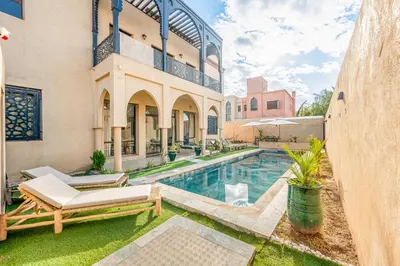 an exterior view of a house with a swimming pool at Andalusian Dream Villa pool and balcony in Marrakech