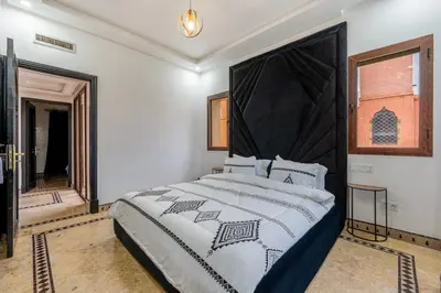 a bedroom with a large bed with a large headboard at Andalusian Dream Villa pool and balcony in Marrakech