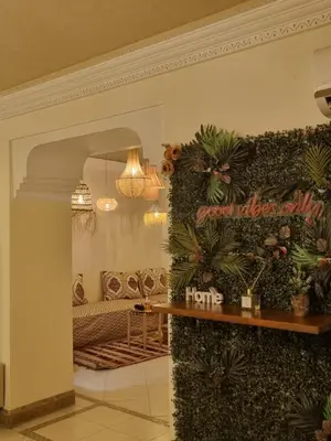 a living room with a couch and plants on a wall at Palais Majorelle - Entire Chic 3Bedrms 3Bathrms Duplex in Marrakech with Majorelle View, 2 Lounges, Prime Central Location in Marrakech