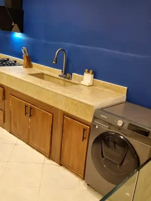 a kitchen with a sink and a washing machine at Palais Majorelle - Entire Chic 3Bedrms 3Bathrms Duplex in Marrakech with Majorelle View, 2 Lounges, Prime Central Location in Marrakech