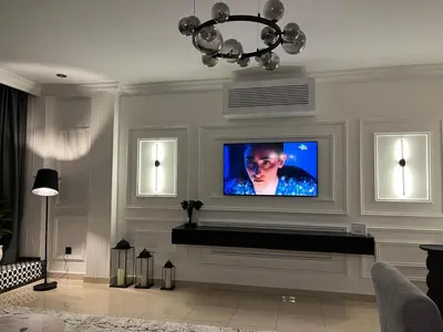 a living room with a flat screen tv on a wall at Amjad in Marrakech