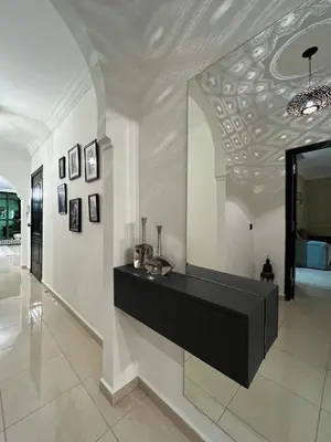 a hallway with a black counter in a building at Amjad in Marrakech