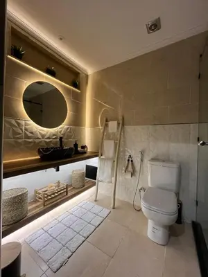 a bathroom with a toilet and a mirror at Amjad in Marrakech