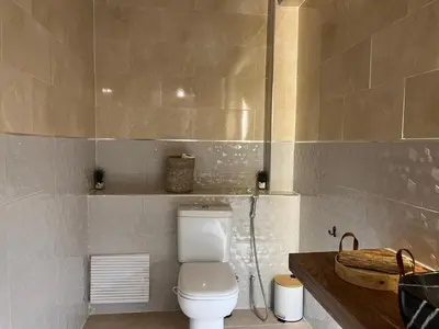 a bathroom with a white toilet and a sink at Amjad in Marrakech