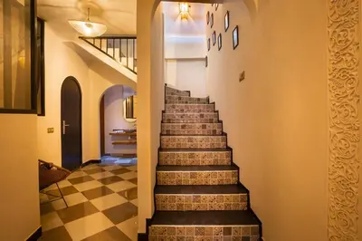 a staircase in a house with a checkered floor at Loft house Marrakech in Marrakech