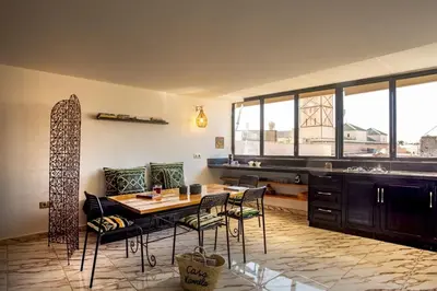 a kitchen with a table and chairs in a room at Loft house Marrakech in Marrakech