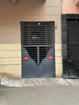 a black garage door with red doors on a building at Hotel-Style Studio - High speed internet - Parking in Marrakech